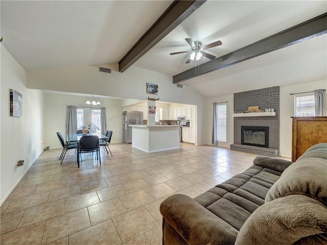 tiled living room featuring french doors, lofted ceiling with beams, ceiling fan with notable chandelier, and a brick fireplace