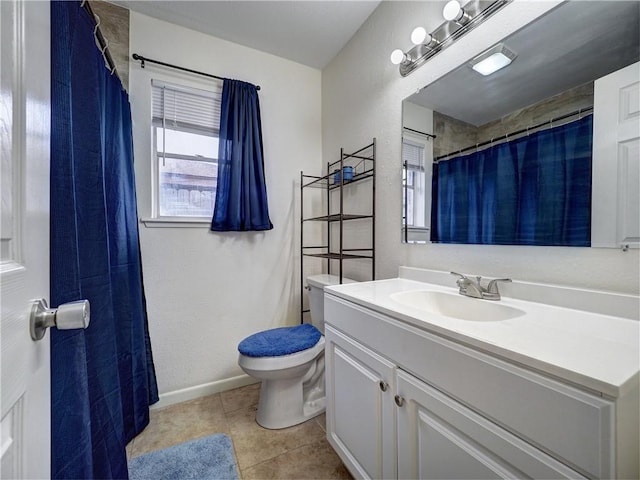 bathroom with tile patterned flooring, vanity, and toilet