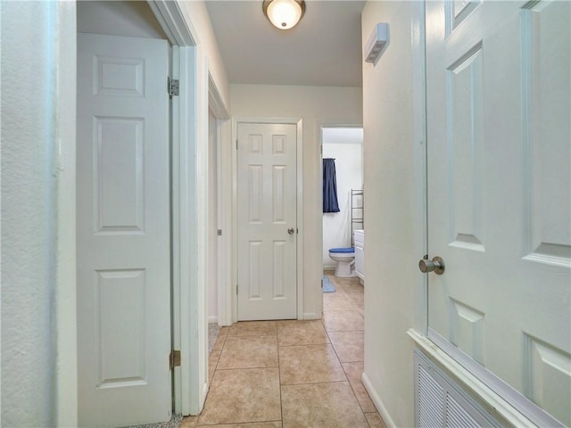 hall with light tile patterned flooring