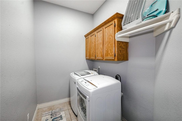 washroom with cabinets and washing machine and clothes dryer