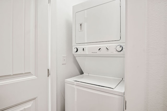 washroom with stacked washer and clothes dryer