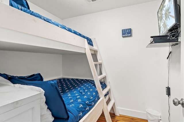 bedroom with wood-type flooring