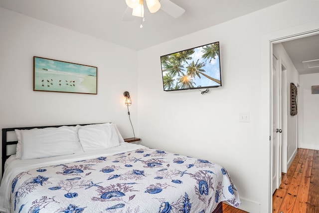 bedroom with hardwood / wood-style floors and ceiling fan