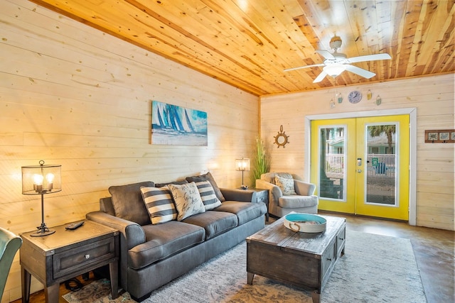 living room featuring concrete flooring, wood ceiling, french doors, and wood walls