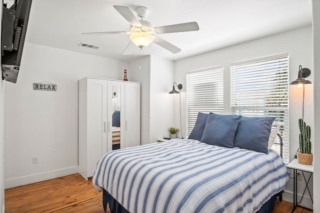 bedroom with hardwood / wood-style flooring and ceiling fan