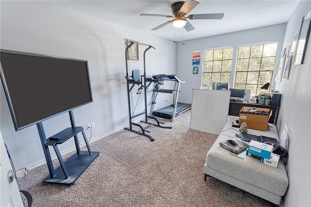 carpeted office space featuring ceiling fan