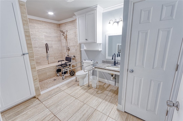 bathroom featuring tiled shower, crown molding, sink, tile patterned flooring, and toilet