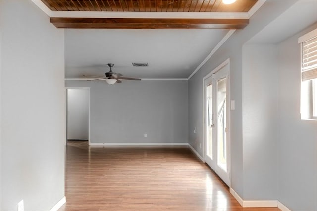 spare room featuring beamed ceiling, crown molding, ceiling fan, and light hardwood / wood-style floors