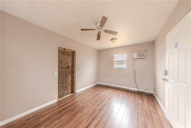 empty room featuring dark wood-type flooring, ceiling fan, and a wall mounted AC