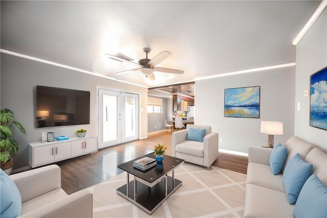 living room with french doors, ceiling fan, and light hardwood / wood-style floors