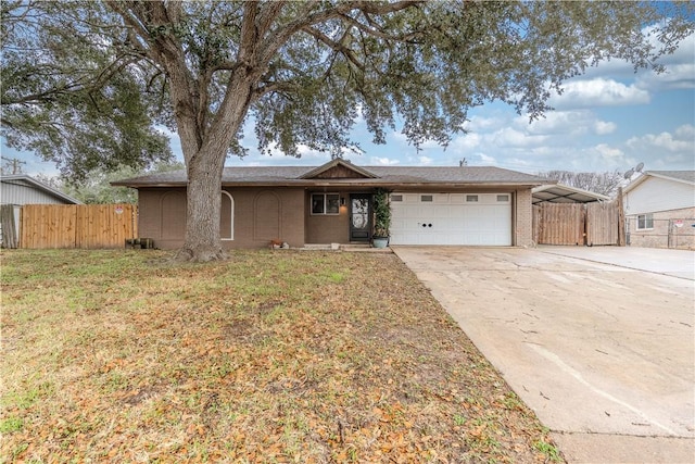 ranch-style house with a garage, a front lawn, and a carport