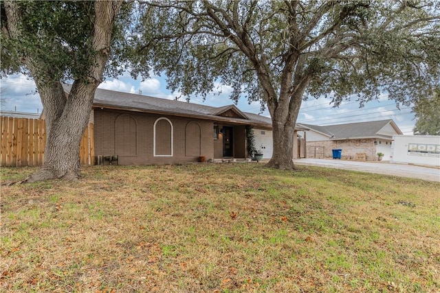 single story home featuring a garage and a front lawn