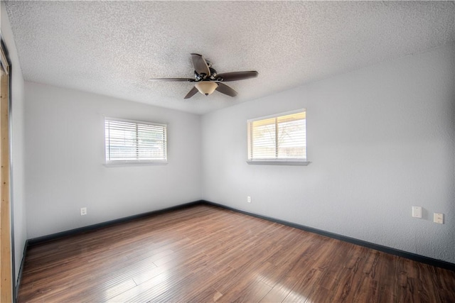 unfurnished room with ceiling fan, wood-type flooring, a textured ceiling, and plenty of natural light