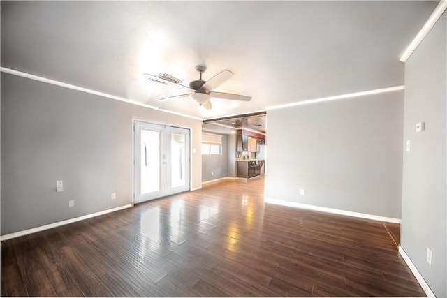 spare room featuring ornamental molding, dark hardwood / wood-style floors, ceiling fan, and french doors