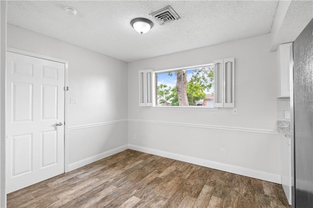 1729 Mermaid Dr, Corpus Christi, TX 78412 - spare room featuring wood finished floors, a textured ceiling, and baseboards