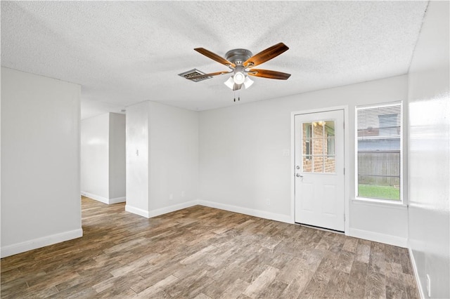 1729 Mermaid Dr, Corpus Christi, TX 78412 - empty room with wood finished floors, a ceiling fan, a textured ceiling, and baseboards
