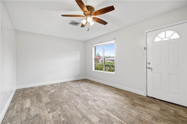 1729 Mermaid Dr, Corpus Christi, TX 78412 - foyer featuring wood finished floors, a ceiling fan, a textured ceiling, and baseboards