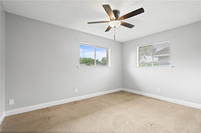 1729 Mermaid Dr, Corpus Christi, TX 78412 - carpeted spare room with healthy amount of natural light, a textured ceiling, a ceiling fan, and baseboards