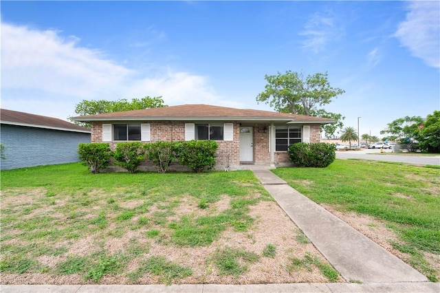 1729 Mermaid Dr, Corpus Christi, TX 78412 - view of front of house with a front yard and brick siding