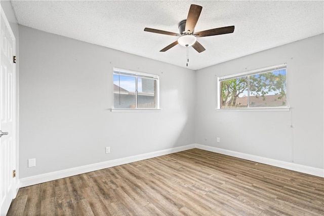 1729 Mermaid Dr, Corpus Christi, TX 78412 - unfurnished room with wood finished floors, a textured ceiling, a ceiling fan, and baseboards