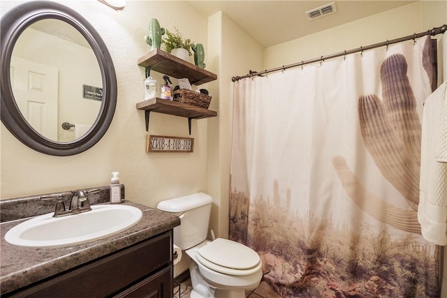 bathroom with toilet and vanity