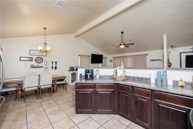 kitchen featuring light tile patterned flooring, vaulted ceiling with beams, pendant lighting, ceiling fan with notable chandelier, and dark brown cabinetry