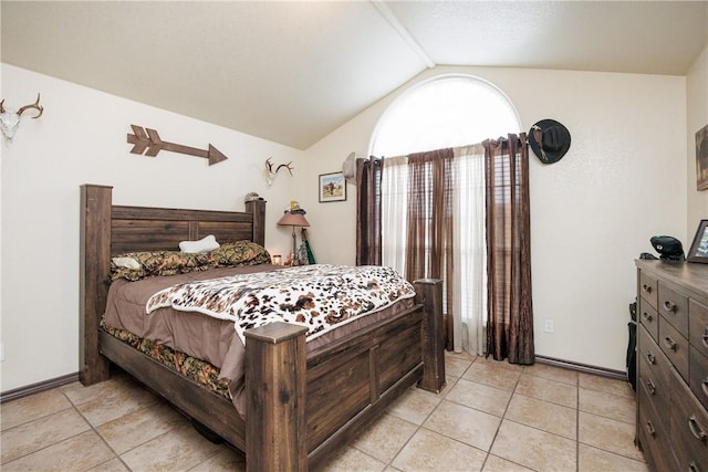 bedroom featuring lofted ceiling and light tile patterned floors