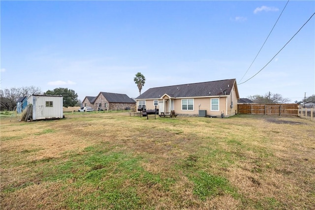 view of yard featuring a storage shed and central AC unit