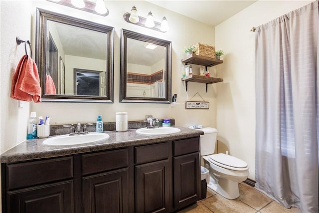 bathroom with tile patterned floors, vanity, and toilet