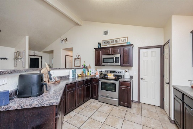 kitchen featuring appliances with stainless steel finishes, vaulted ceiling with beams, kitchen peninsula, light tile patterned flooring, and dark brown cabinets