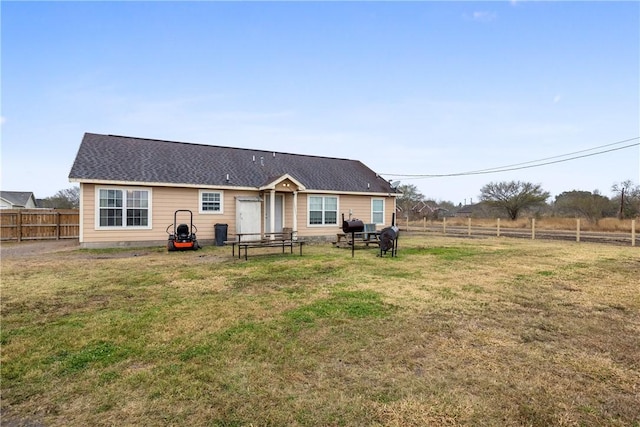 back of house featuring a yard