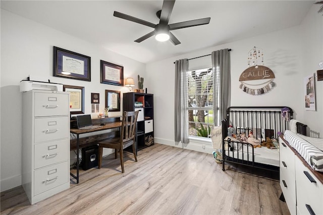 bedroom with baseboards, ceiling fan, and light wood-style floors
