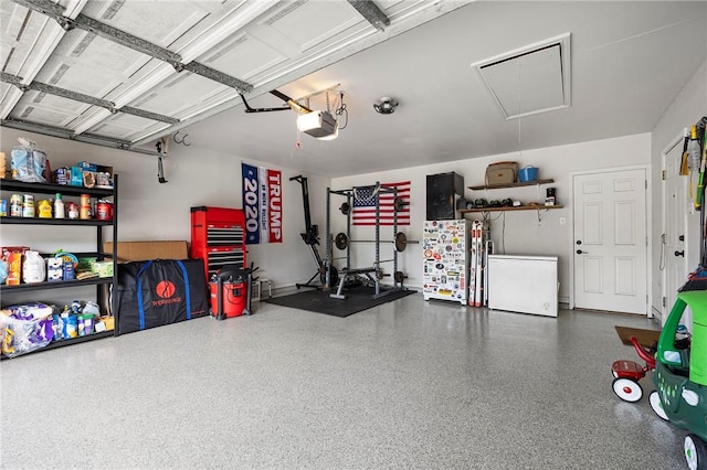 garage with fridge and a garage door opener