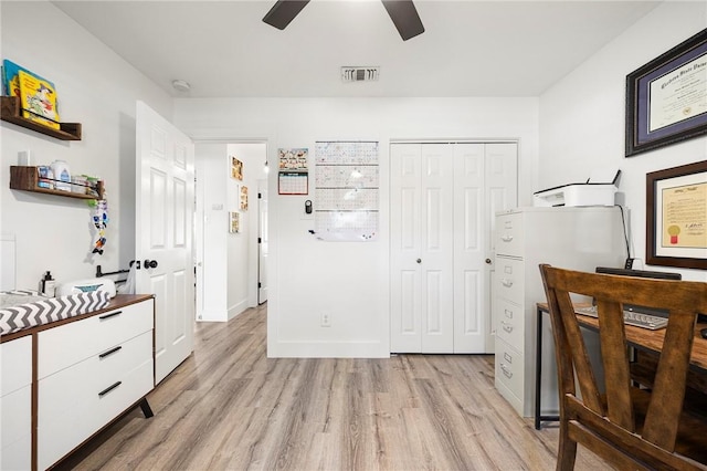 interior space with visible vents, light wood finished floors, and ceiling fan