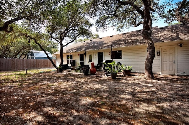 back of property with fence