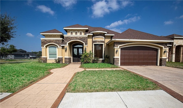 view of front facade with a garage, a front yard, and french doors