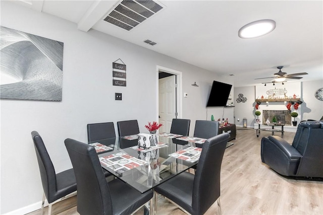 dining area with hardwood / wood-style floors and ceiling fan