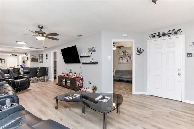 living room with ceiling fan and light hardwood / wood-style floors