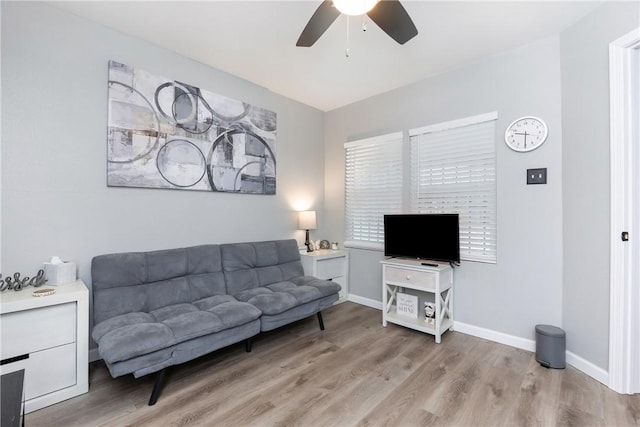 living room with light hardwood / wood-style floors and ceiling fan