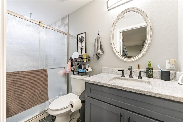 bathroom with vanity, toilet, and an enclosed shower