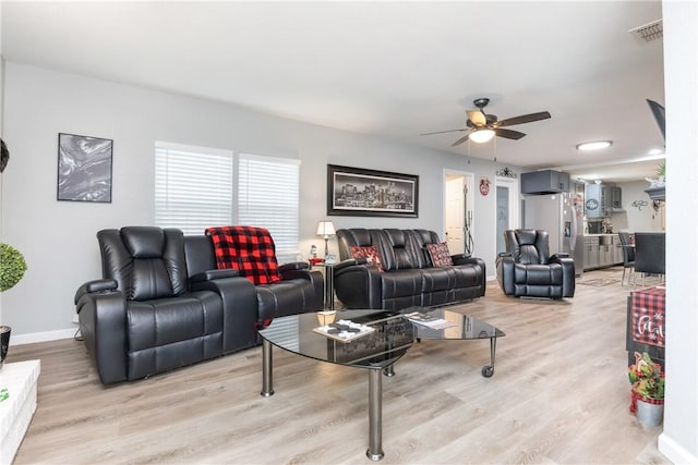 living room with ceiling fan and light wood-type flooring