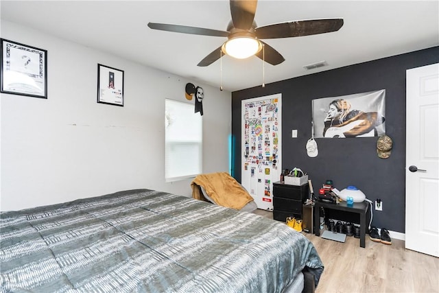 bedroom with hardwood / wood-style flooring and ceiling fan