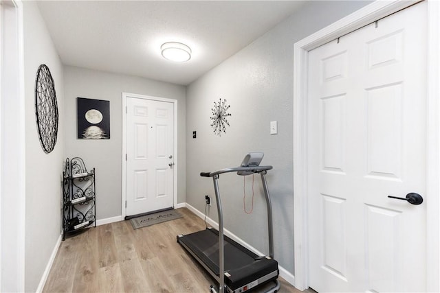 exercise area with light wood-type flooring