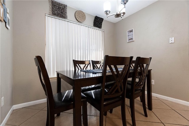 tiled dining area with a notable chandelier