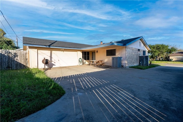 single story home featuring cooling unit and a patio area