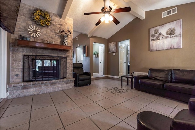 tiled living room featuring a brick fireplace, a textured ceiling, ceiling fan, and lofted ceiling with beams