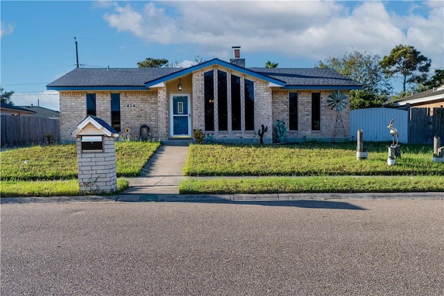 ranch-style house with a front lawn