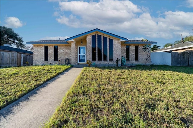 ranch-style house with a front lawn