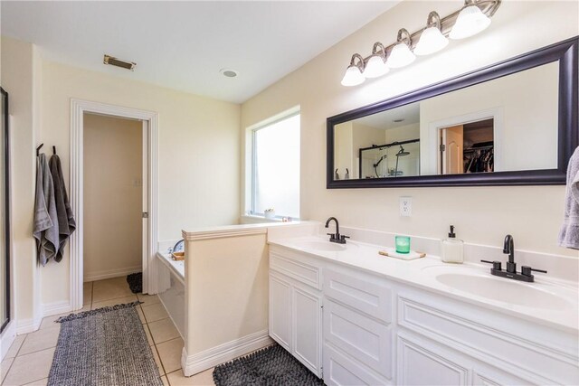 bathroom featuring tile patterned flooring, a shower stall, and a sink