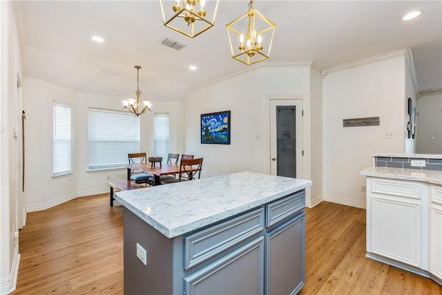 kitchen featuring visible vents, an inviting chandelier, light wood-style flooring, recessed lighting, and hanging light fixtures